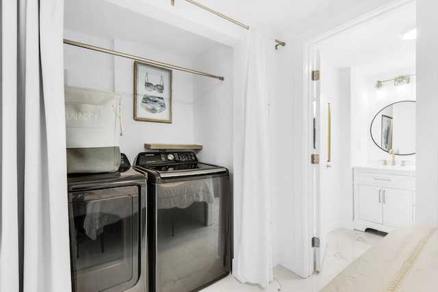 washroom featuring washer and dryer and sink