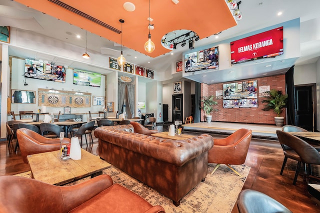 living room featuring hardwood / wood-style flooring and a high ceiling