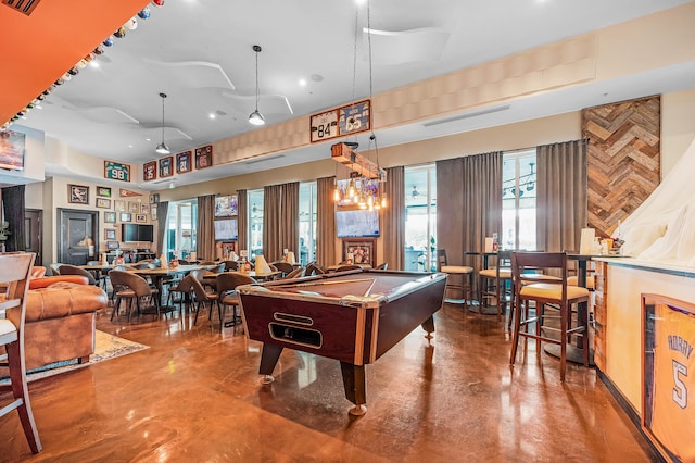 recreation room featuring pool table, concrete floors, and wood walls