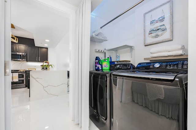 laundry area with washing machine and dryer