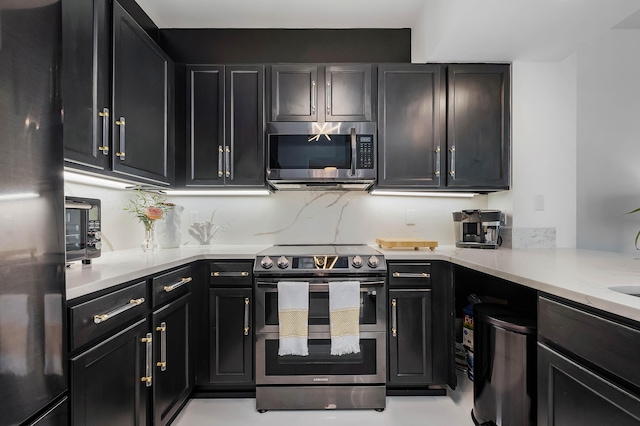 kitchen with light stone countertops and stainless steel appliances