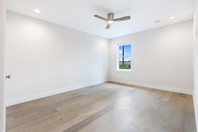 empty room with ceiling fan and light hardwood / wood-style flooring