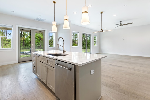 kitchen featuring sink, dishwasher, ceiling fan, a center island with sink, and pendant lighting