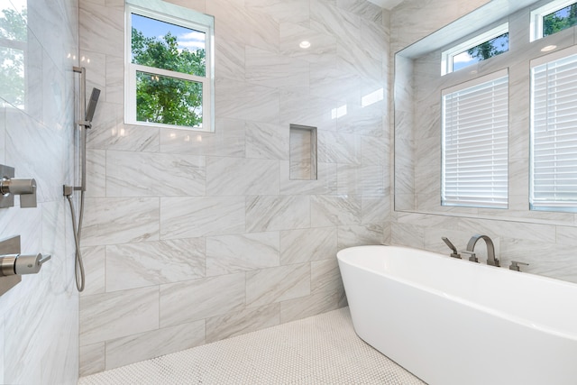 bathroom with separate shower and tub and plenty of natural light