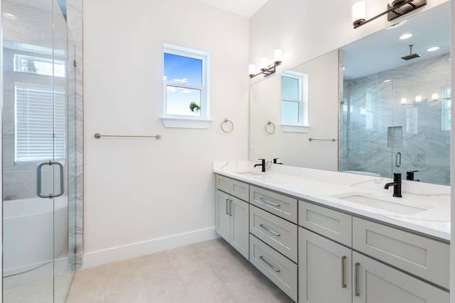 bathroom with an enclosed shower, vanity, and tile patterned floors