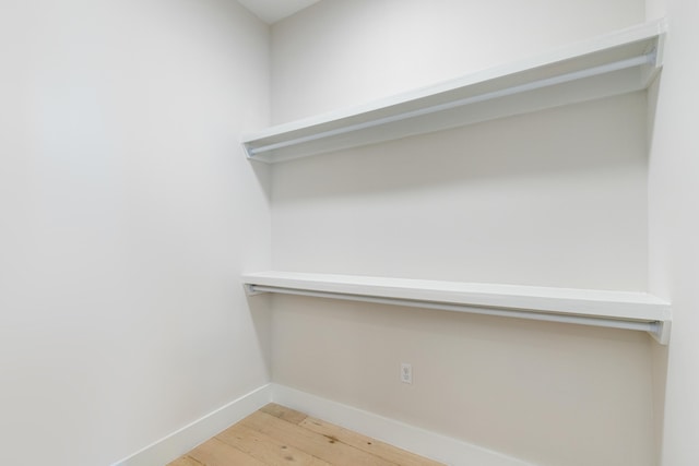 spacious closet featuring light hardwood / wood-style flooring