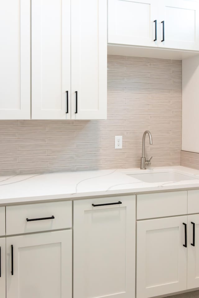 kitchen featuring white cabinets and sink