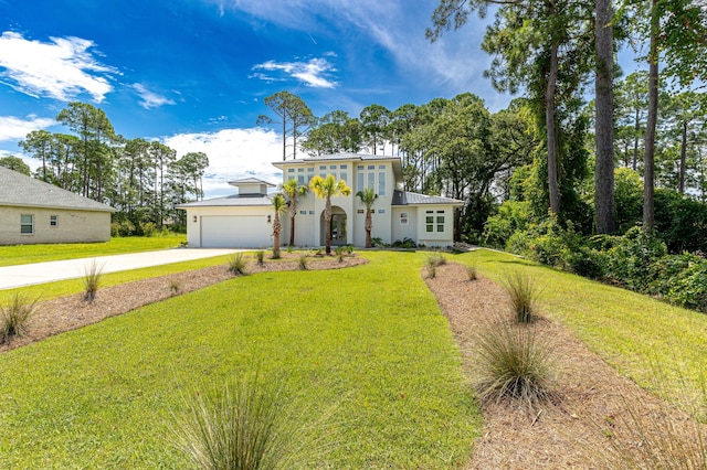 view of front of house featuring a front lawn and a garage