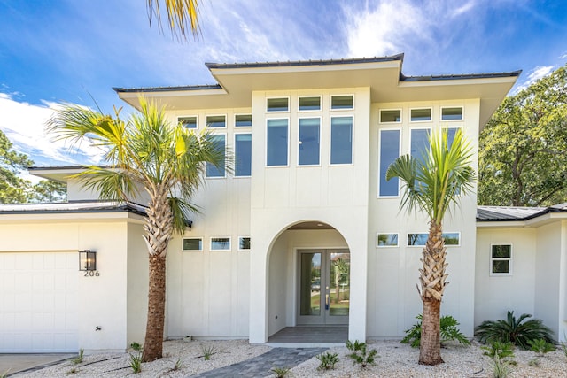 view of front facade with french doors and a garage