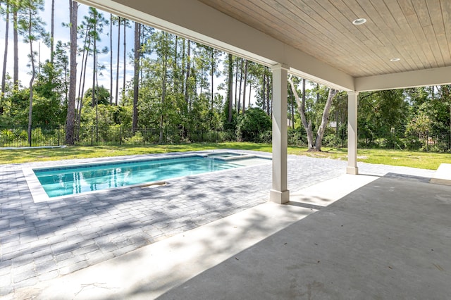 view of pool with a patio area and a lawn