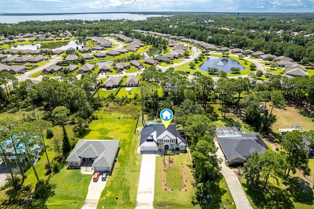 birds eye view of property with a water view