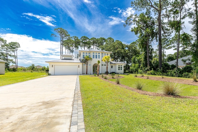 view of front of property with a front yard and a garage