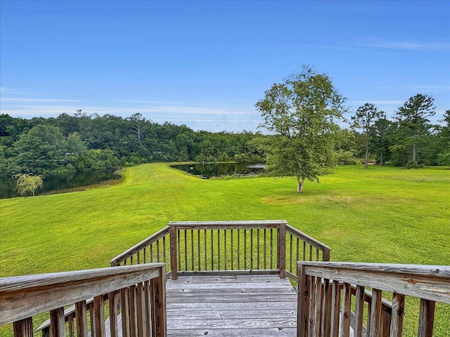 wooden deck with a yard and a water view