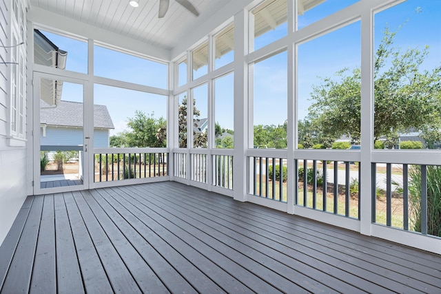 unfurnished sunroom featuring ceiling fan