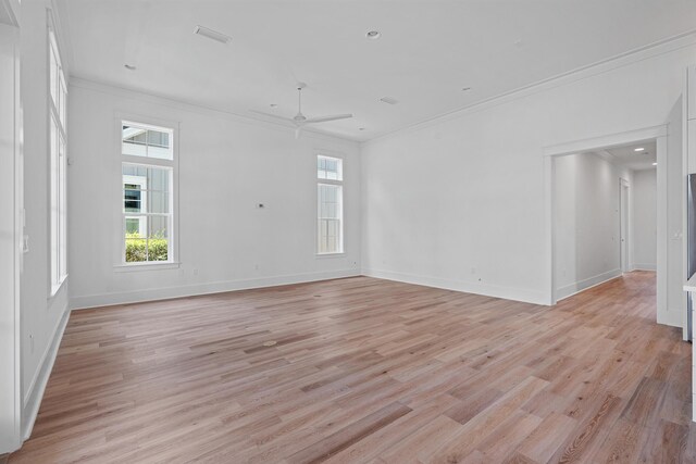 empty room featuring ceiling fan, ornamental molding, and light hardwood / wood-style flooring