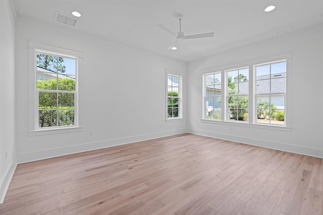 empty room with ceiling fan, light hardwood / wood-style flooring, and a healthy amount of sunlight