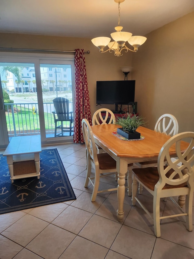 dining space with tile floors and an inviting chandelier