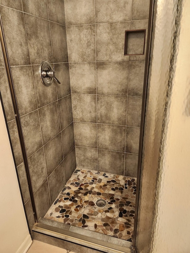 bathroom with a tile shower