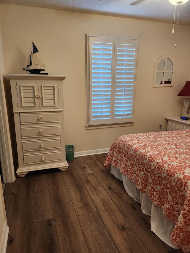 bedroom featuring dark hardwood / wood-style flooring and ceiling fan