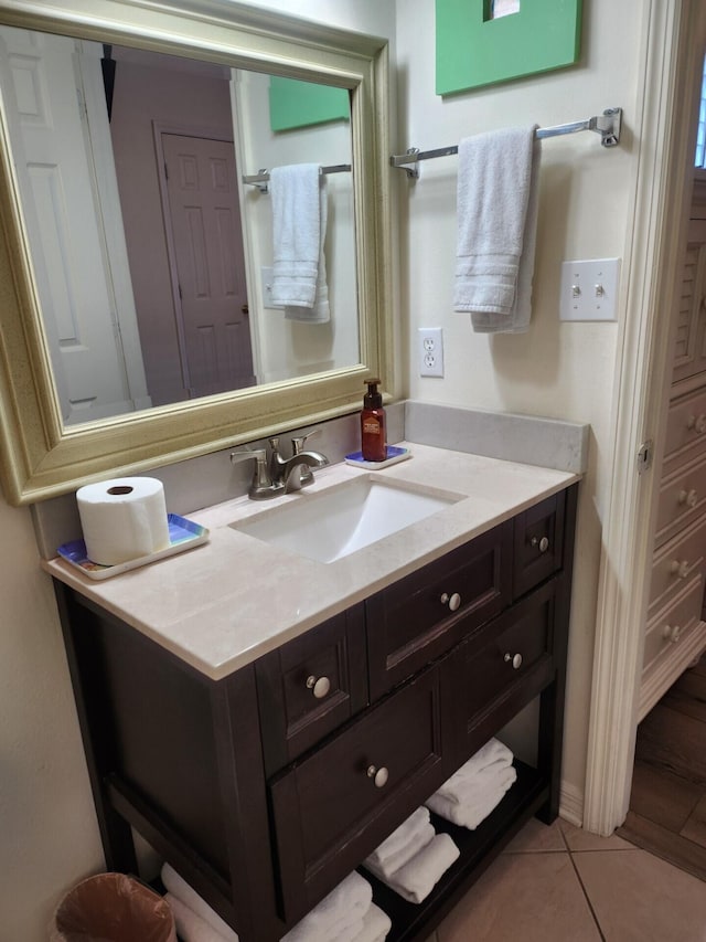 bathroom with tile flooring and vanity