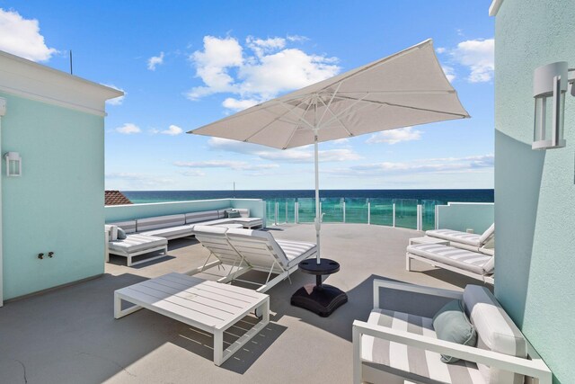 view of patio featuring outdoor lounge area, a water view, and a balcony