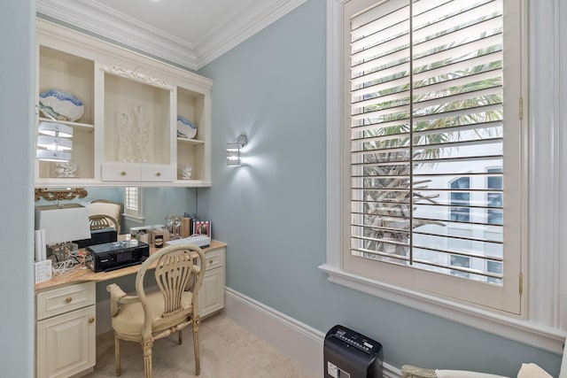 home office with ornamental molding, built in study area, and baseboards