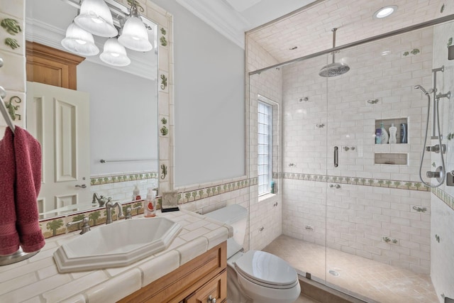 bathroom with ornamental molding, a stall shower, vanity, and toilet