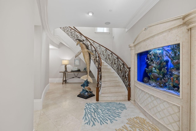 staircase featuring ornamental molding and baseboards