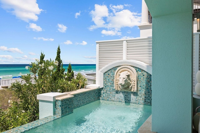 view of pool with a water view