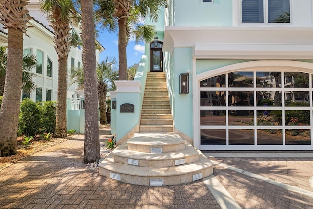 doorway to property featuring stucco siding