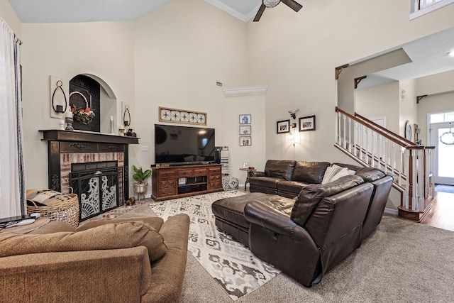 living room featuring high vaulted ceiling, ceiling fan, hardwood / wood-style floors, and a brick fireplace