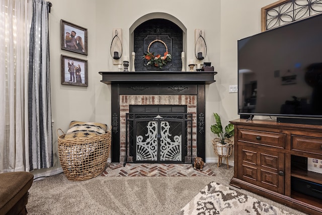 living room featuring carpet flooring and a fireplace