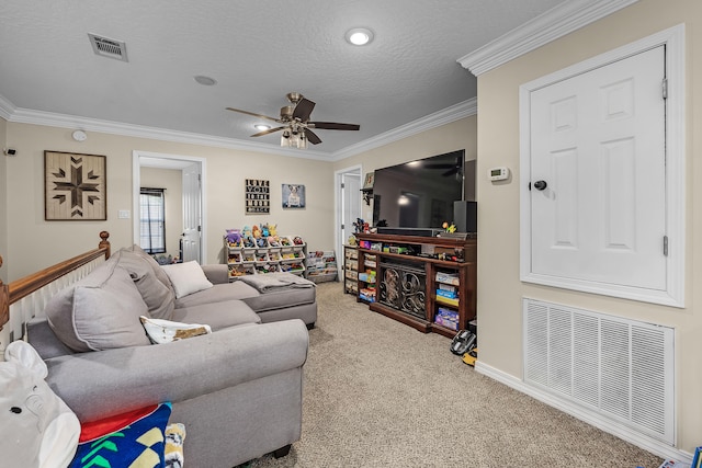 living room featuring a textured ceiling, ornamental molding, carpet floors, and ceiling fan