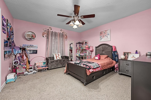 carpeted bedroom featuring ceiling fan and a textured ceiling