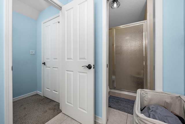 bathroom featuring walk in shower and tile flooring