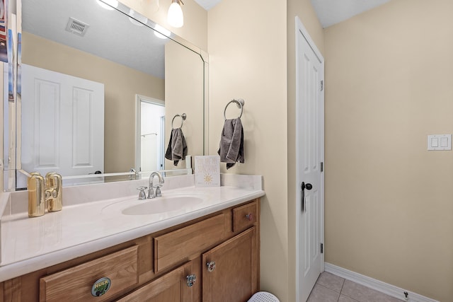 bathroom with tile flooring and vanity