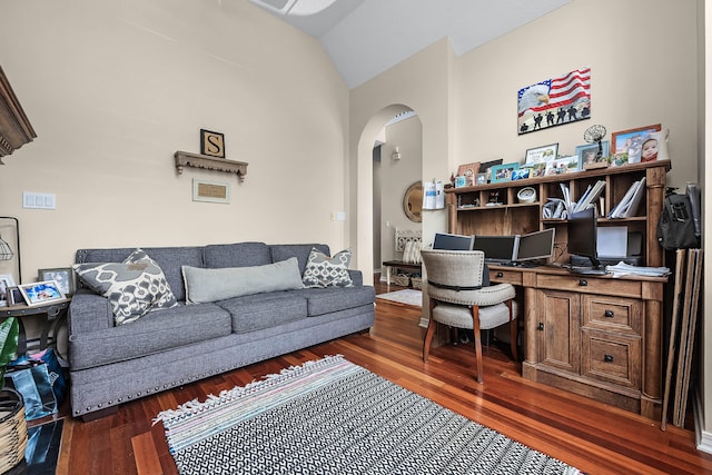 living room featuring lofted ceiling and dark hardwood / wood-style flooring