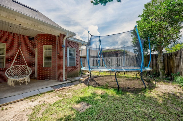 view of yard with a patio and a trampoline