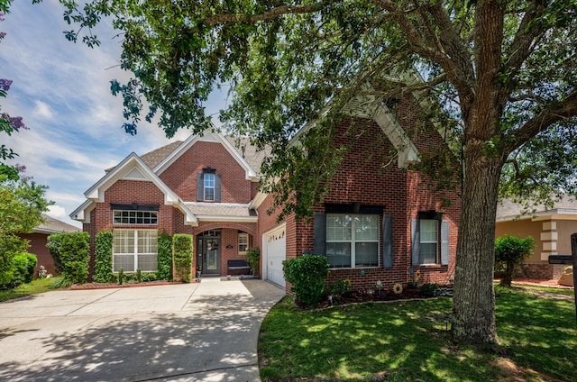 view of front of property featuring a garage and a front yard