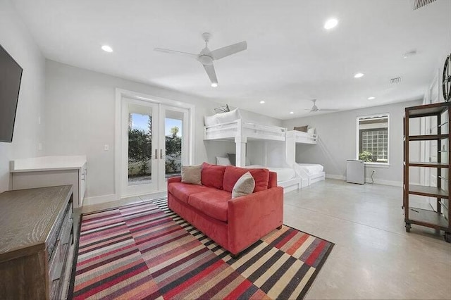 living room featuring ceiling fan, french doors, and concrete flooring