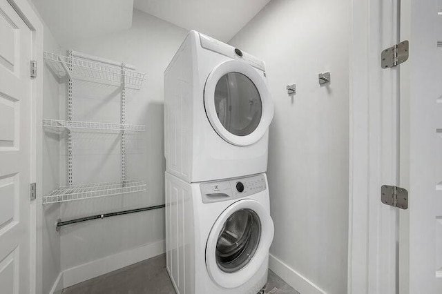 laundry area with stacked washer and clothes dryer