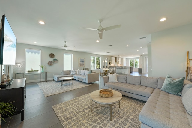 living room featuring ceiling fan and tile floors