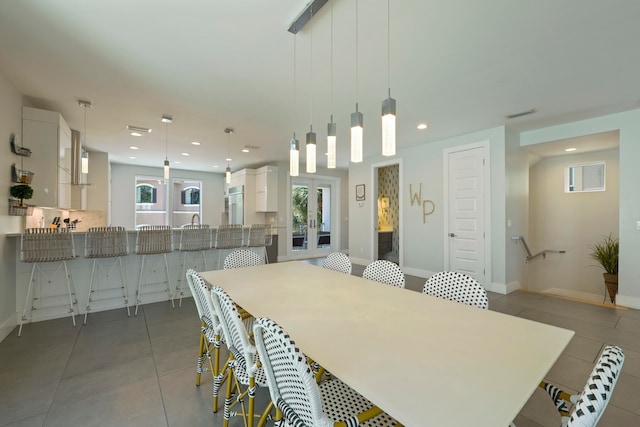 dining space featuring tile flooring and french doors