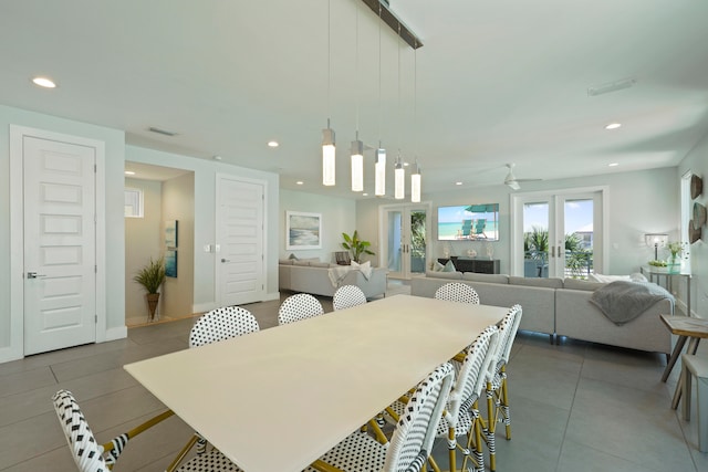 dining space featuring french doors, tile flooring, and ceiling fan