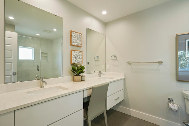 bathroom with tile flooring, walk in shower, double sink, and vanity with extensive cabinet space