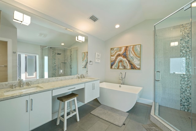 bathroom with independent shower and bath, double sink, lofted ceiling, tile floors, and large vanity