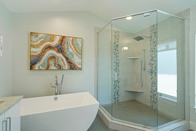 bathroom with tile flooring, independent shower and bath, vanity, and vaulted ceiling