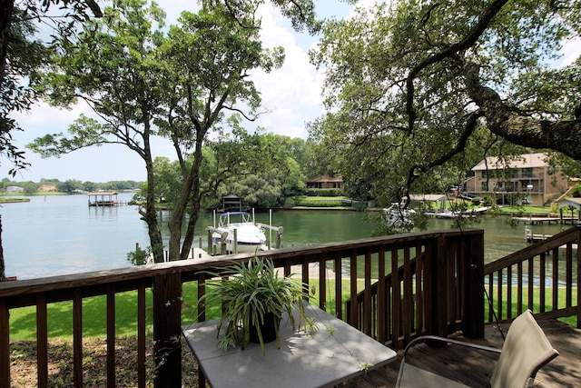 wooden terrace with a boat dock and a water view