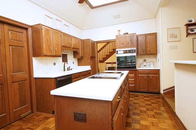 kitchen featuring white cooktop, brown cabinetry, stainless steel dishwasher, and oven