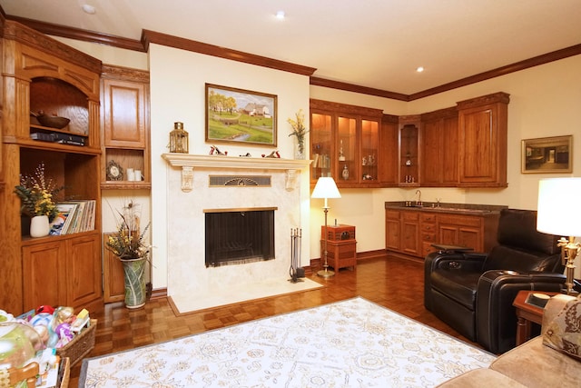 living room featuring baseboards, ornamental molding, and a high end fireplace